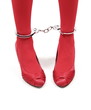Restraint. Woman red legs in handcuffs