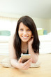 Laughing woman listening music lying on the floor Laughing woman listening music lying on the floor