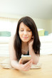 Caucasian woman listening music lying on the floor Caucasian woman listening music lying on the floor