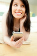 Charming woman listening music lying on the floor Charming woman listening music lying on the floor