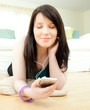 Dreamy woman listening music lying on the floor Dreamy woman listening music lying on the floor