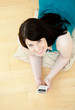 Relaxed woman listening music lying down on the floor Relaxed woman listening music lying down on the floor