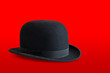 Bowler hat on red background