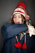 Woman sneezing into her arm