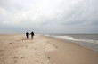 Photo: Couple is walking on the beach Couple is walking on the beach