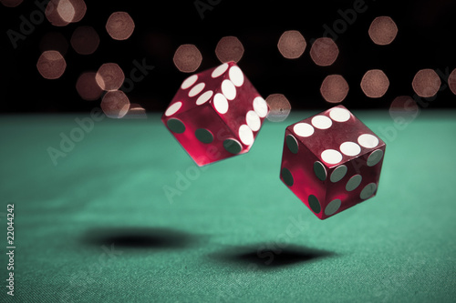 Photo: two dice rolling on table two dice rolling on table