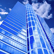 clouds in glazed panel skyscraper