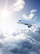 Airplane in the sky - cloudy but sunny day
