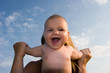 Mother keeps her child's hands on the beach