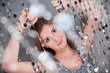 Girl with purple nails in silver dress holding beads
