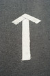 White arrow on asphalt White arrow on asphalt