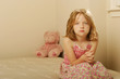 Photo: Sad girl sitting on an old mattress Sad girl sitting on an old mattress