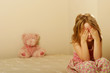 Photo: Sad girl sitting on an old mattress Sad girl sitting on an old mattress