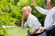 Foto: Happy senior couple on bridge waving hands Happy senior couple on bridge waving hands