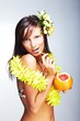 Beautiful exotic girl drinking grapefruit juice