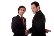 two businessmen shaking hands, businessman with fingers crossed