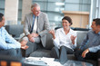 Business people enjoying a casual talk at the office lounge