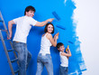 Photo: Young family painting the wall Young family painting the wall