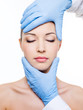 Plastic surgery touching female face