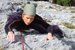 Rock climbing. Young woman climbing a limestone rock Rock climbing. Young woman climbing a limestone rock