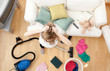 Depressed blond woman vacuuming the living-room Depressed blond woman vacuuming the living-room