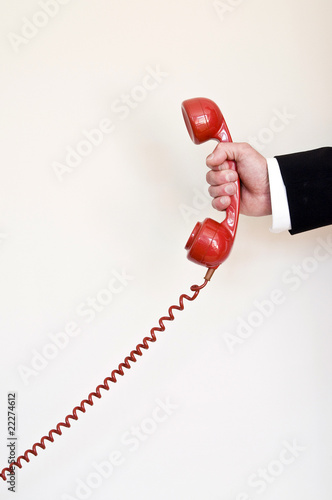 Photo: holding red telephone holding red telephone