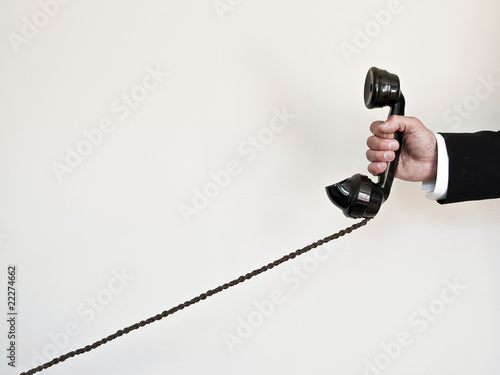 Photo: holding retro telephone holding retro telephone