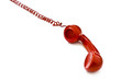 Red telephone receiver on white