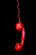 Red telephone receiver on black