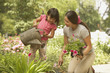 Asian mother and young daughter gardening