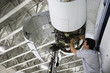 Middle Eastern repairman working on airplane engine