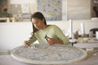 African mosaic artist working in studio