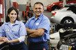 Female and male auto mechanics in auto repair shop