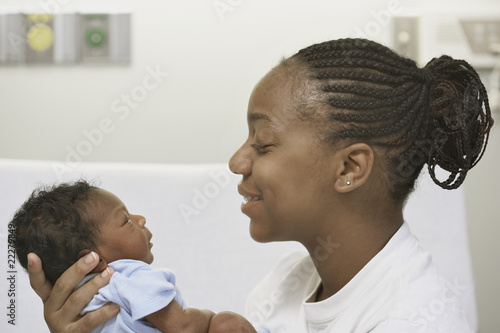 Photo: Close up of African mother smiling at newborn baby Close up of African mother smiling at newborn baby