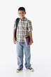 Studio shot of Hispanic boy carrying backpack and books