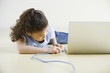 African girl plugging in laptop