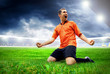 Happiness football player after goal on the field of stadium wit Happiness football player after goal on the field of stadium wit