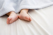 Russian baby's feet sticking out from blanket