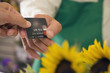 Customer paying with credit card at florist