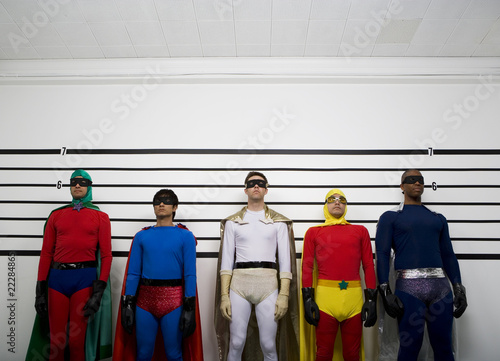 Photo: Multi-ethnic superheroes standing police line up Multi-ethnic superheroes standing police line up