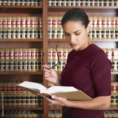 Photo: Hispanic female lawyer reading Hispanic female lawyer reading