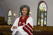 African American female Reverend with arms crossed