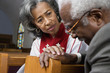 African American female Reverend talking to parishioner