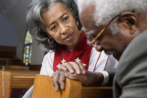 Photo: African American female Reverend talking to parishioner African American female Reverend talking to parishioner