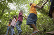 Hispanic children exploring woods