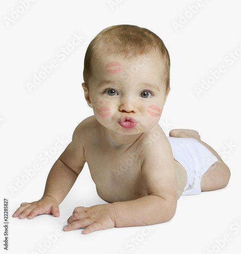 Photo: Studio shot of baby blowing kiss Studio shot of baby blowing kiss
