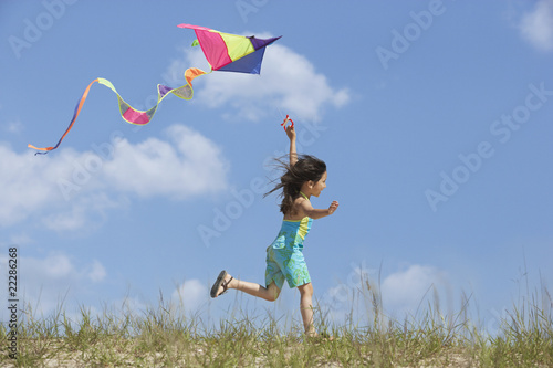 Photo: Hispanic girl flying kite Hispanic girl flying kite