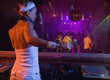 Hispanic woman djing at nightclub