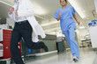 Medical professionals running in hallway