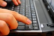 Finger pressing backspace button on laptop